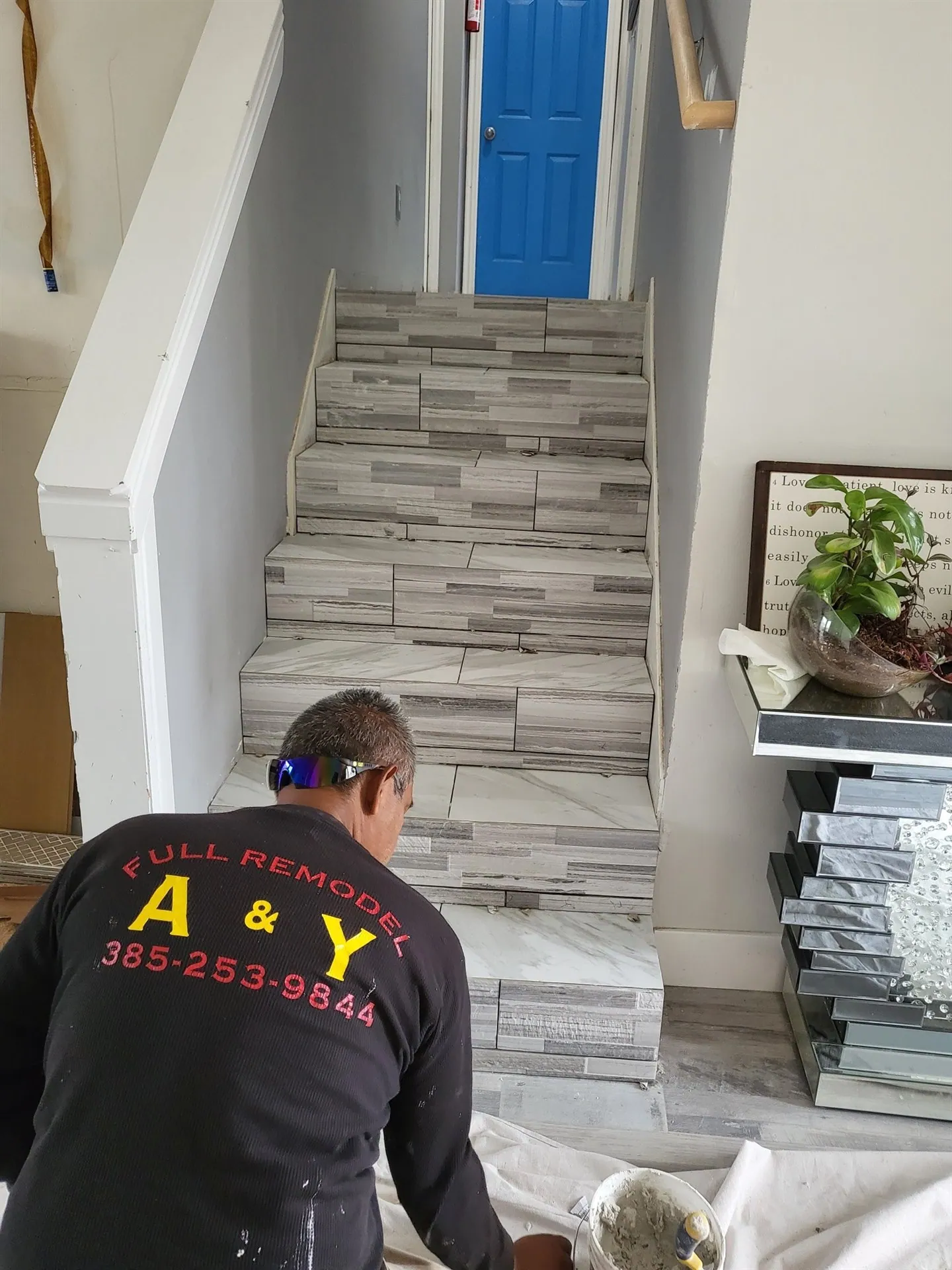 A and Y installer tiling a staircase