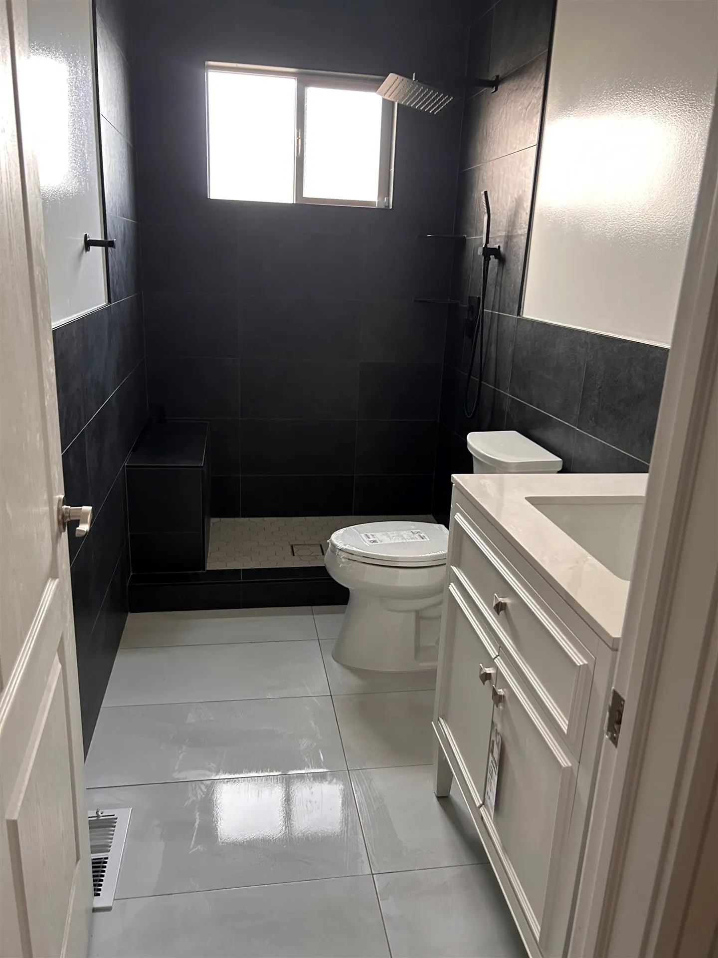 Two-tone bathroom with charcoal tile wainscot