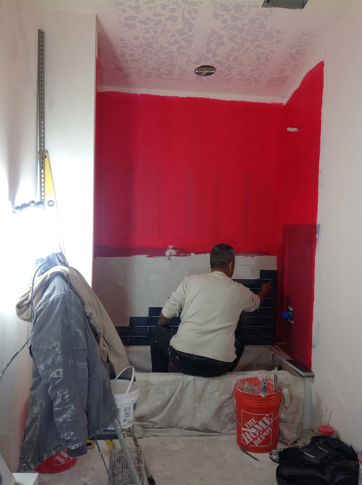 Shower pan waterproofed in red membrane before tile