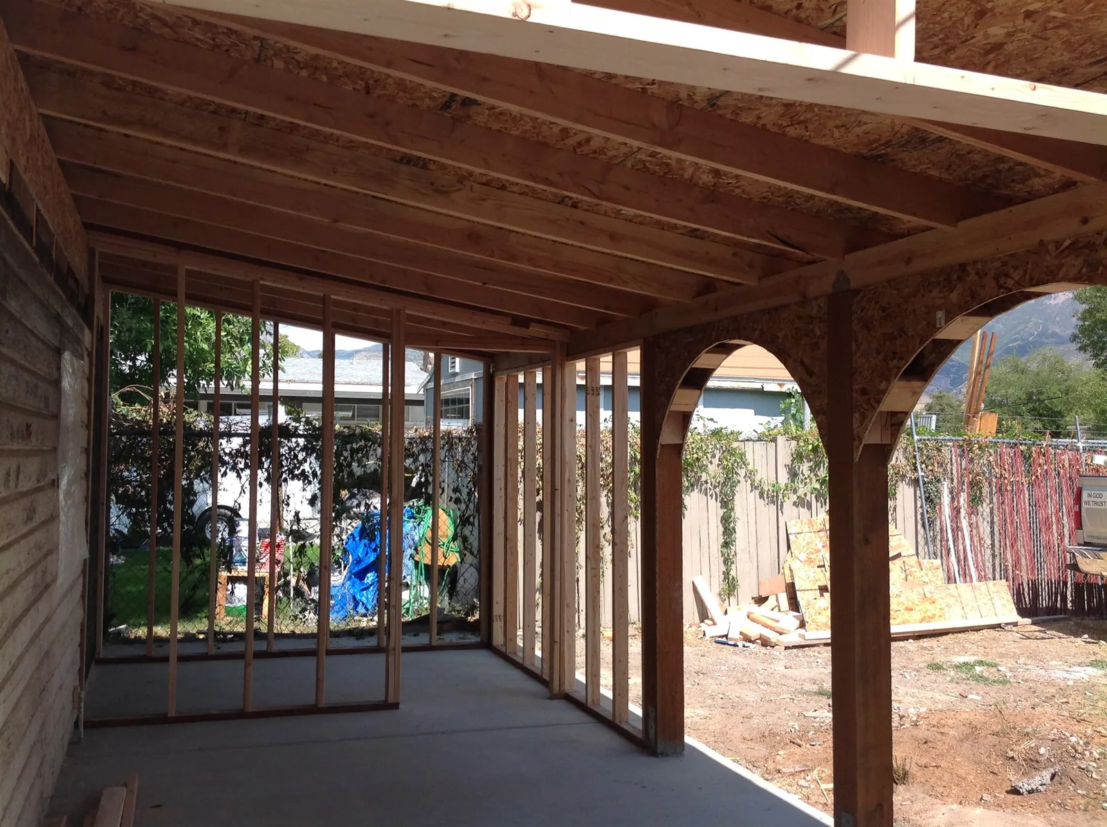 Timber-framed covered patio with arched openings