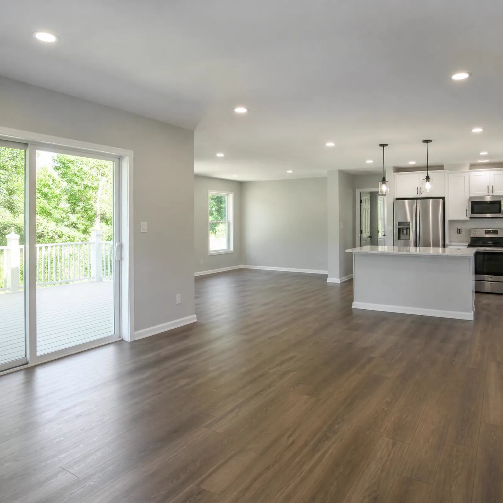 Open living space with new luxury vinyl plank flooring and fresh interior paint