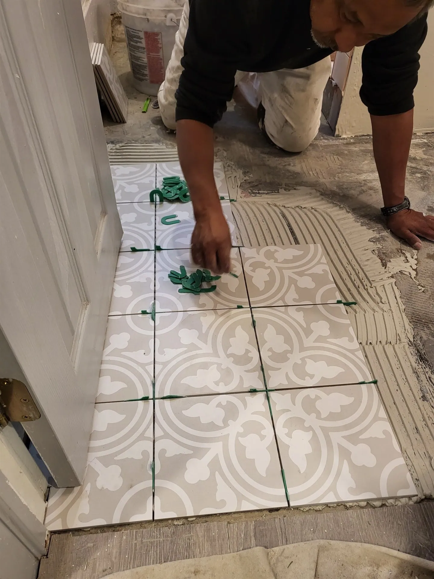 Patterned encaustic floor tile being set