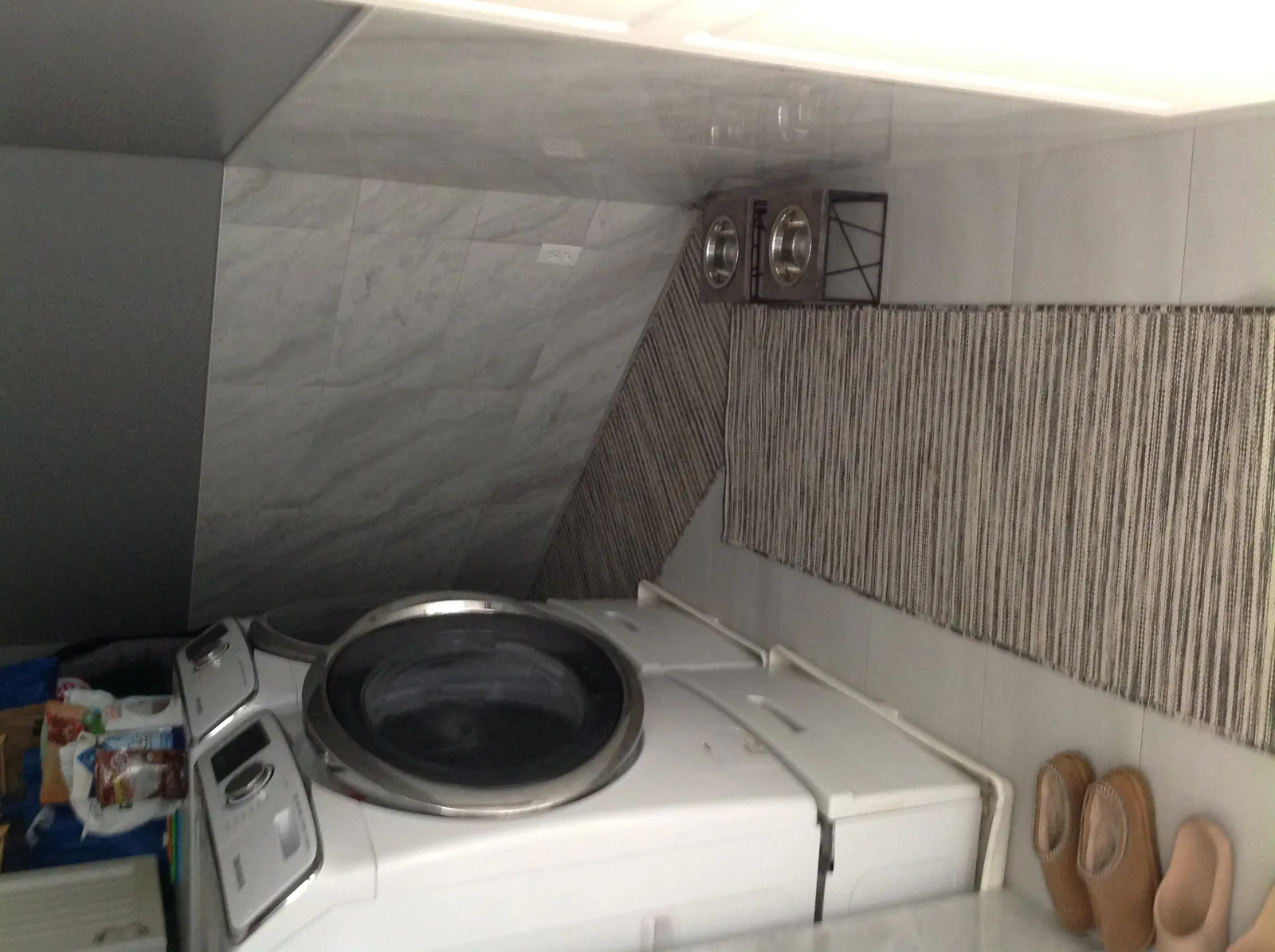Laundry area with tiled wainscot and plank floor