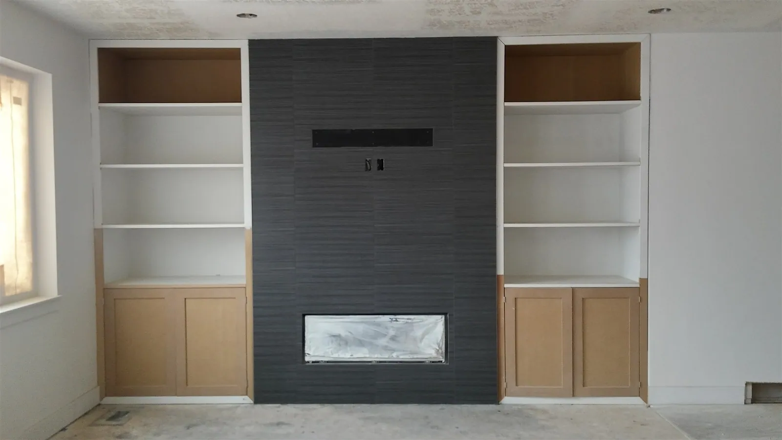 Built-in entertainment center with tiled fireplace surround